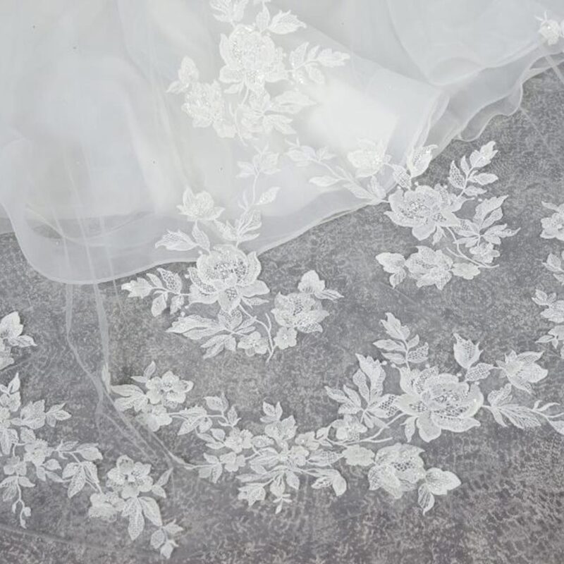 Italian lace appliqué have been hand stitched to created this surround of beautiful large floral detail.