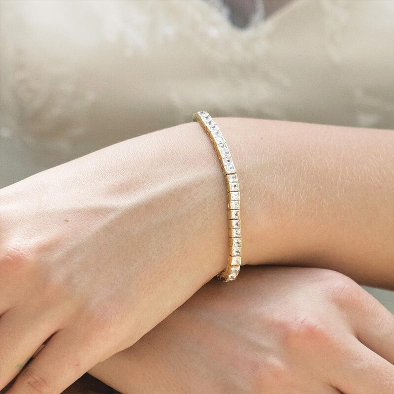 This is a very elegant tennis bracelet. Square cut stones are surround set and as this bracelet complements so many different style wedding gowns it is a very popular design. This delicate bracelet is understated and subtle but still sparkly and sophisticated.
