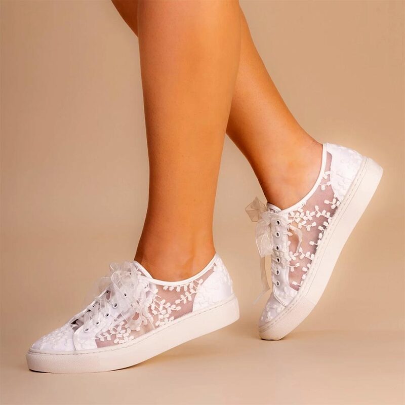 Oakley is a beautiful bridal sneaker handcrafted from unlined ivory lace with ivory satin counter and toe cap, finished with sheer organza laces. Delicate embroidered lace on a sheer mesh backing ensure these pretty sneaker with pair perfectly with any bridal gown.
