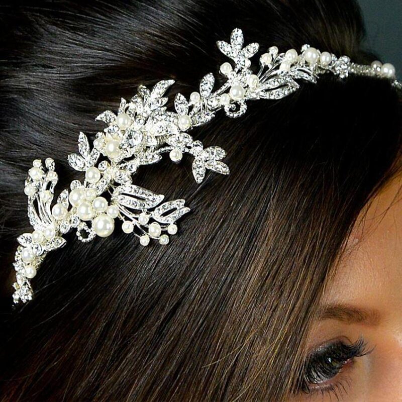 Detailed side tiara with crystal and pearl detailing which continues around the band with the main feature being on the right depending on which way the tiara is worn.