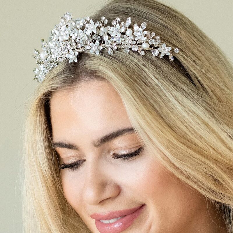 A beautiful and romantic floral wedding tiara handcrafted with delicate silver enamelled flowers, sparkling crystals and luminous ivory pearls.