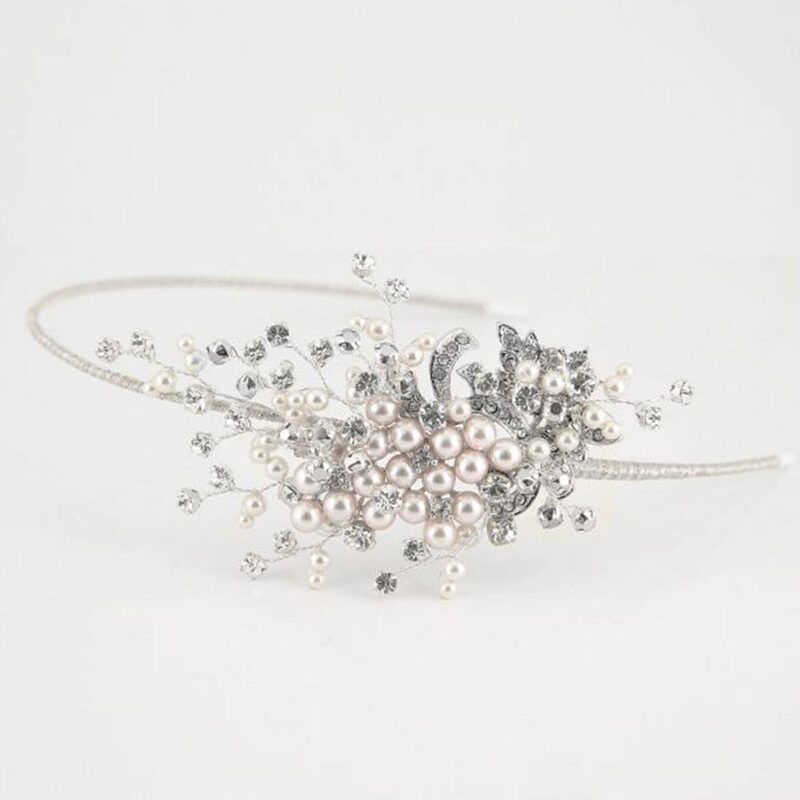 This shimmering crystal and pearl side tiara has a beautiful mix of crystal and pearl sprays, and silver brooch detailing.