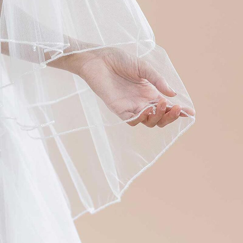 This beaded edge fingertip bridal veil is infinitely twirl-worthy!